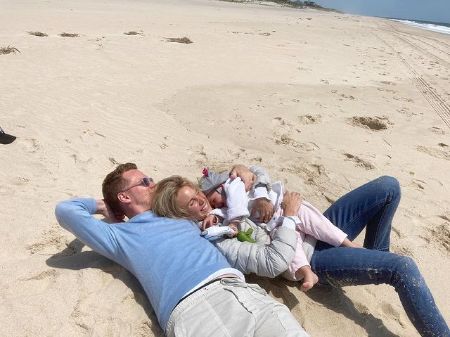 Tessa was wearing white jacket, t-shirt and pants, and her husband was wearing t-shirt and pants.